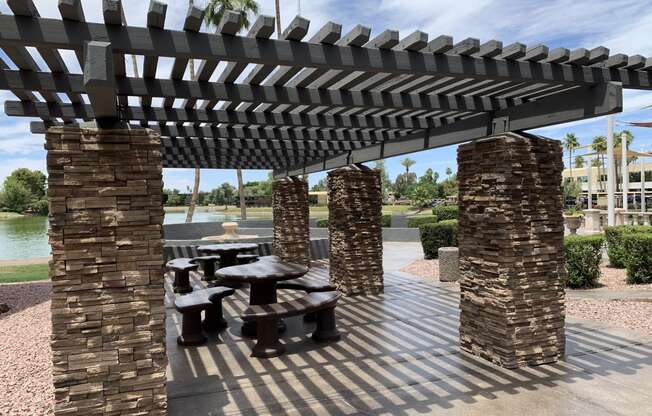 a picnic area with benches and a pergola