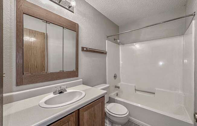 a bathroom with a sink and a toilet and a shower at Creekstone Falls, Sioux Falls, South Dakota