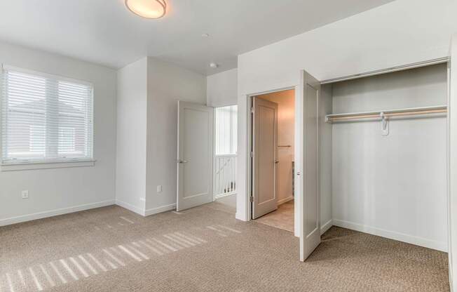 A room with a carpeted floor and a sliding door.