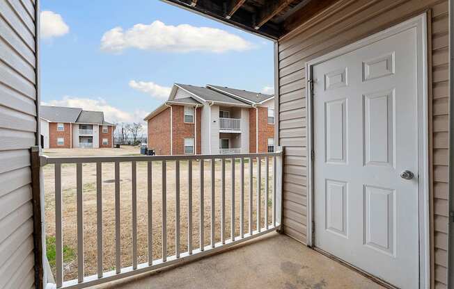 A view from a balcony looking out at apartment buildings.