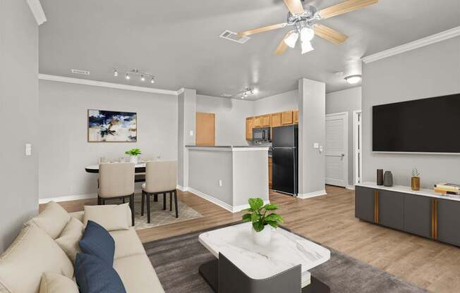 A modern living room with a beige sofa and a white coffee table.