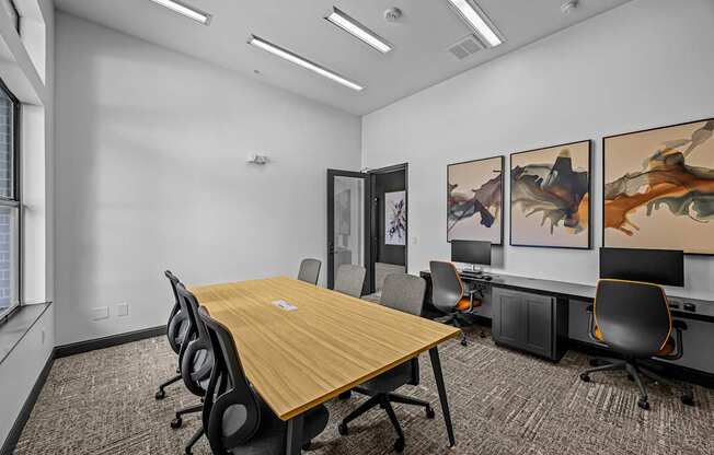 A conference room with a long table and chairs.