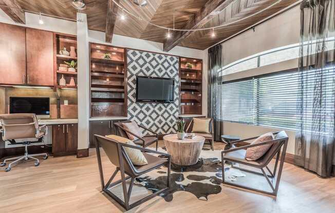 A modern living room with a wooden floor and a television mounted on the wall.