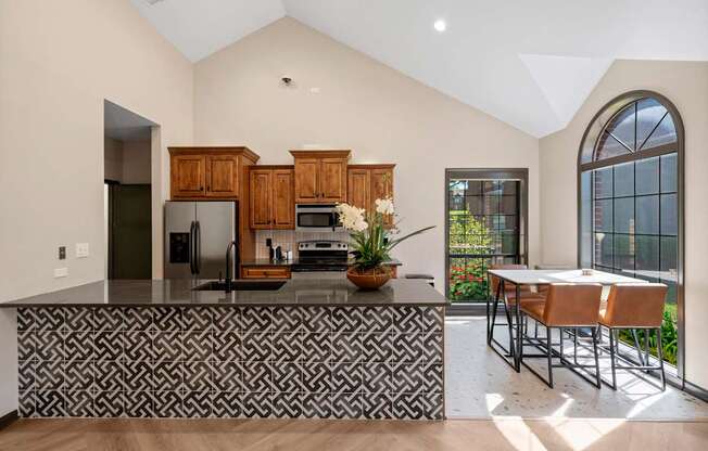 A kitchen with a black and white patterned bar.