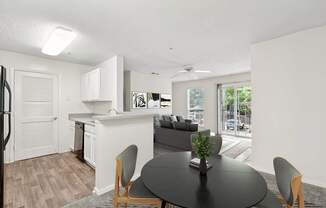 A modern kitchen with a dining table and chairs.