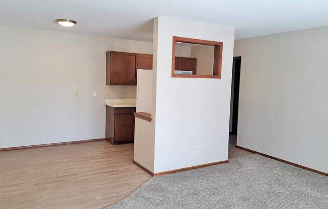 A room with a small kitchenette and a window.
