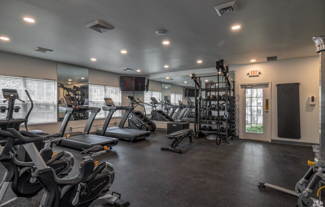 a gym with treadmills and other exercise equipment