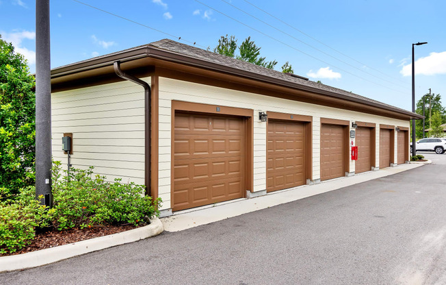 a row of garages with brown doors