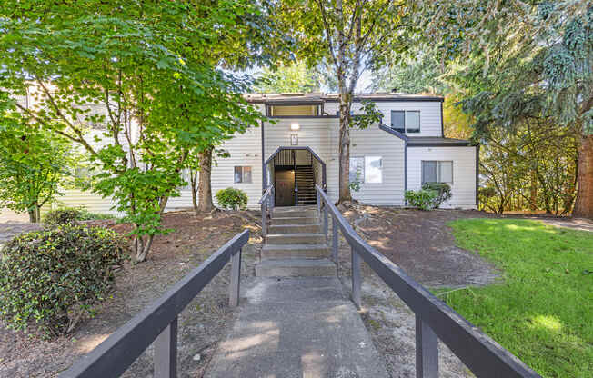 the front of a house with a path leading up to it