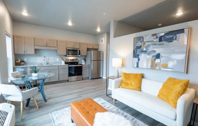 a living room with a couch and a table and a kitchen