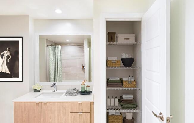 Bathrooms at Modera Aventura feature sleek vanities and convenient linen storage for everyday ease.