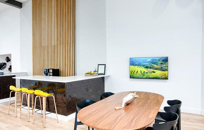 a dining room with a wooden table and black chairs at Presidio Palms Apartments, Tucson