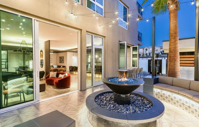 Enjoy a cozy fire pit near the pool at Modera Pomona for a relaxing outdoor experience.