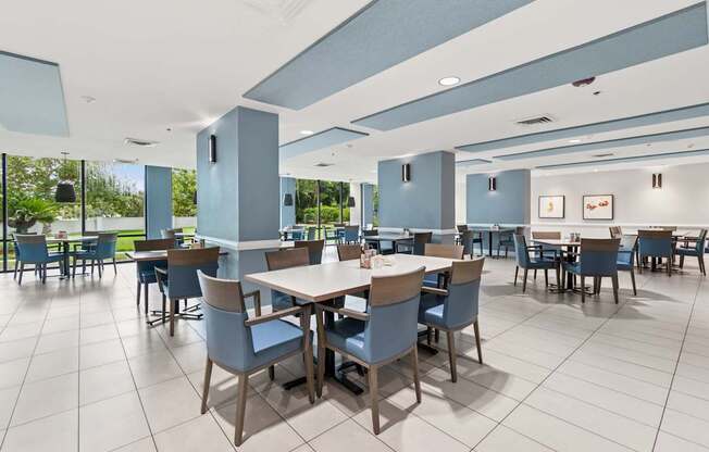 A large dining room with tables and chairs at Hampton Apartments, Florida, 33759