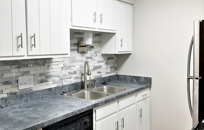 a kitchen with a sink and a mirror