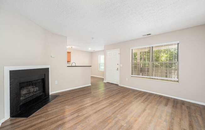 a living room with a fireplace and a window