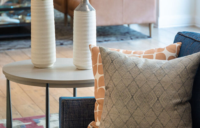 a living room with a couch and a table with vases on it