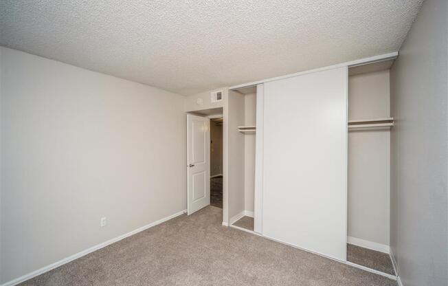 Bedroom with white walls and a closet  at Avery Park in Englewood, CO