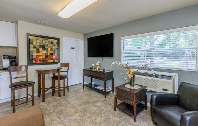 a living room filled with furniture and a large window