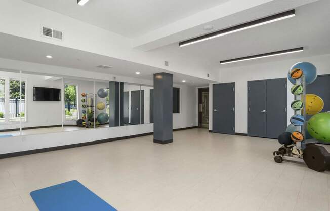 a large multipurpose room with white walls and a beige tile floor at The Flats at Riverwoods, Provo, UT