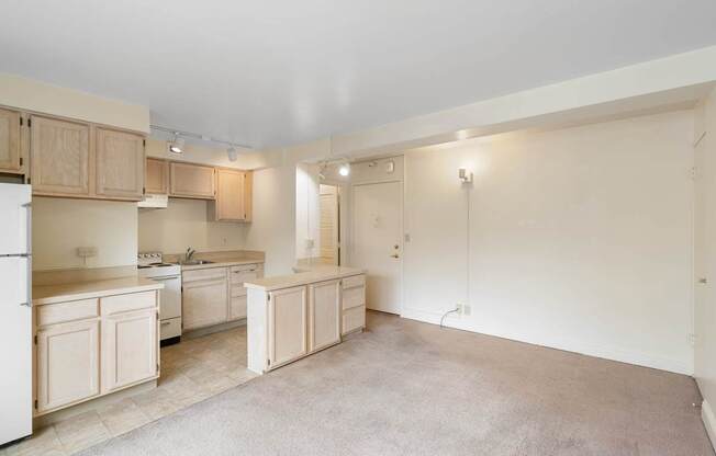 a kitchen with white cabinets and a sink and a refrigerator