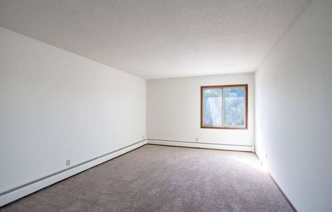 a blank room with carpet and a window. Eagan, MN Glen Pond Apartments