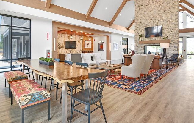 a living room with a wooden table and a fireplace