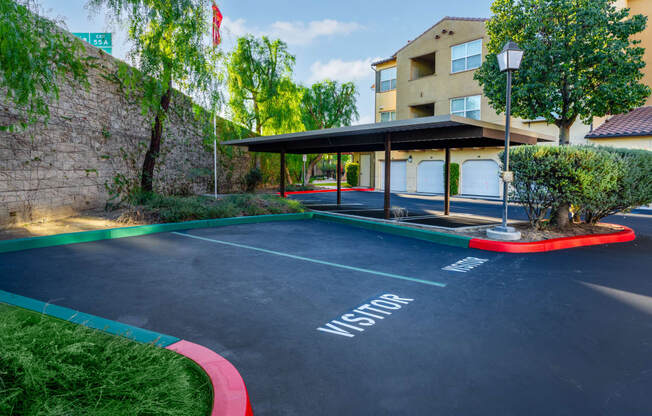 an empty parking lot with a building in the background