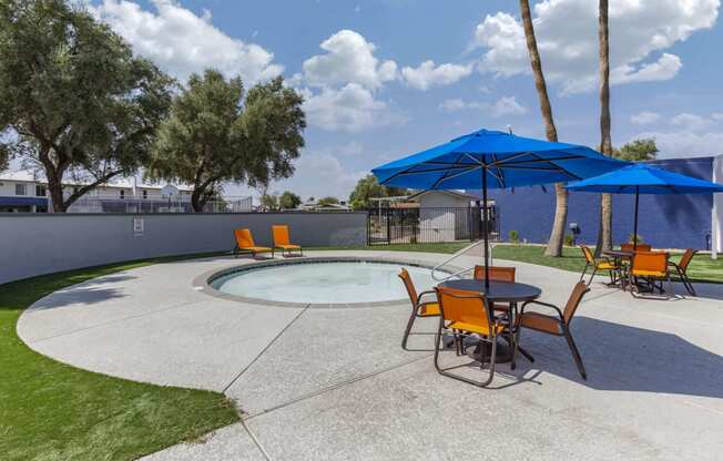 our apartments have a pool and patio with umbrellas