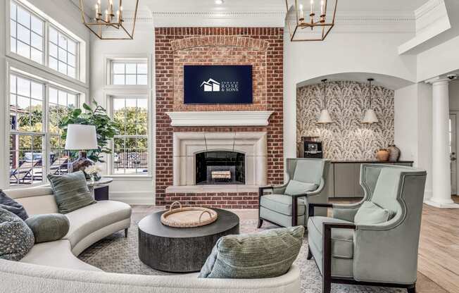 a living room with furniture and a brick fireplace