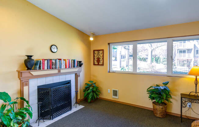 the living room of a house with a fireplace and windows