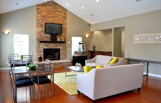 white couch, brick firplace, wall-mounted TV