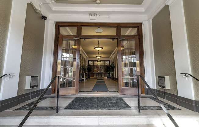 a view of the entrance to the lobby of a building with glass doors at The Knights @ 506 Delaware Apartments, Buffalo, NY 14202