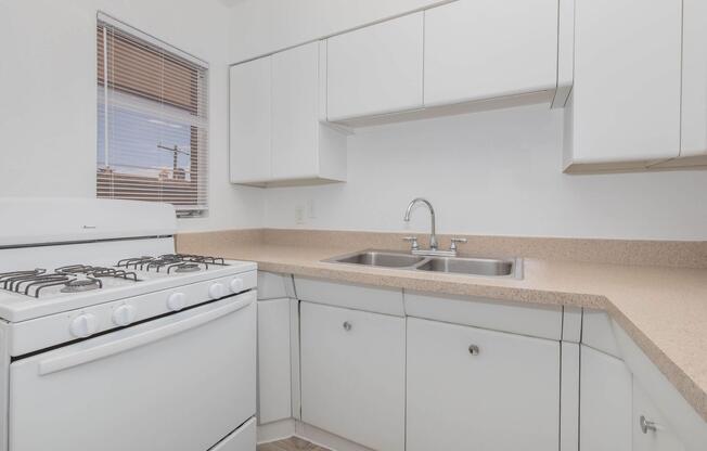 a kitchen with a stove and a sink