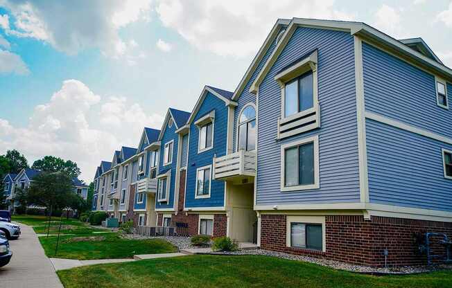 A building with blue siding and white trim at South Bridge Apartments, Fort Wayne, IN, 46816