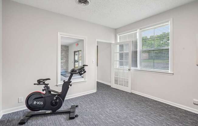 A room with a stationary bike in it.