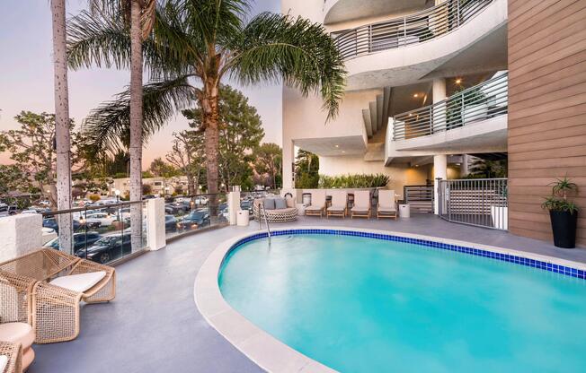 A resort-style pool with lounge seating and a relaxed outdoor setting.