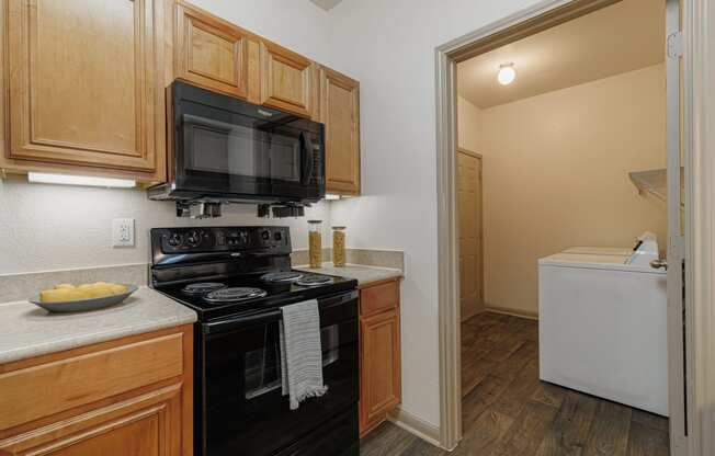 a kitchen with a stove and a microwave and a refrigerator