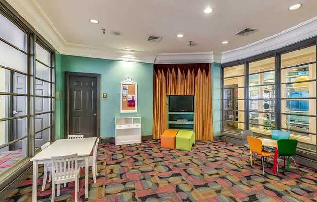 a living room with a table and chairs and a television