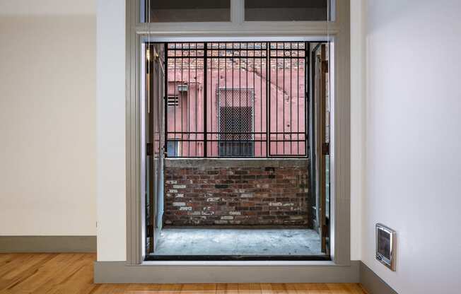 a view of a brick building through an open door