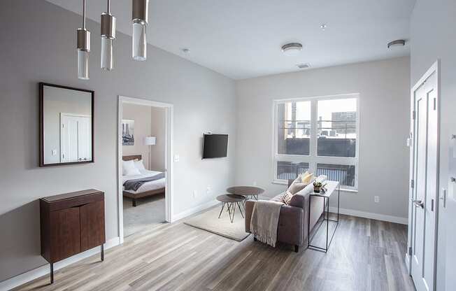 a living room with gray walls and hardwood floors