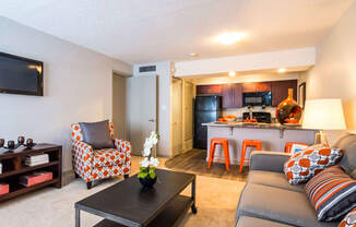 a living room and kitchen with a couch and a table at Skyview Apartments, Westminster, CO