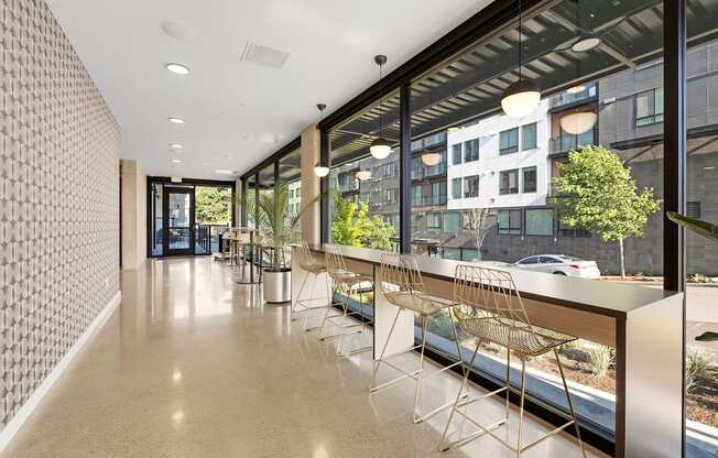 a long corridor with a long counter and a row of chairs in front of a large window at Ion Town Center, Shoreline Washington