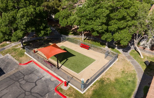 an aerial view of a park with a basketball court and a red court