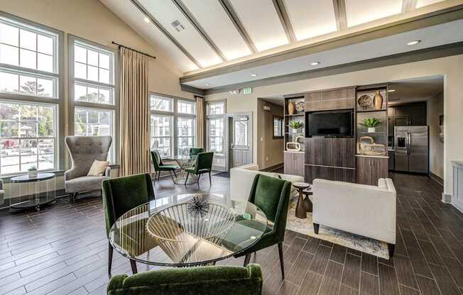 a living room with green chairs and a glass table