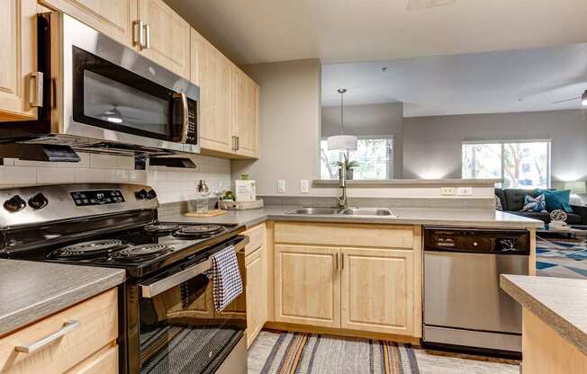 A kitchen with wooden cabinets and stainless steel appliances.