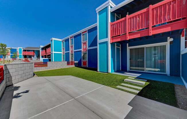 A blue and red building with a white door and windows.