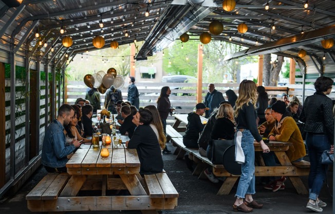 a group of people sitting at tables in a beer tent