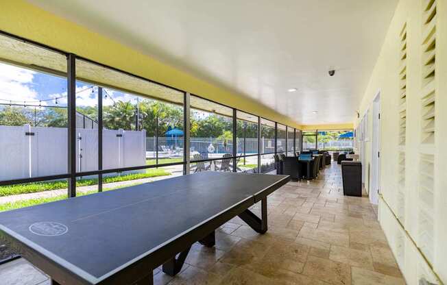 A long table with a logo on it is in the middle of a room with a yellow ceiling.