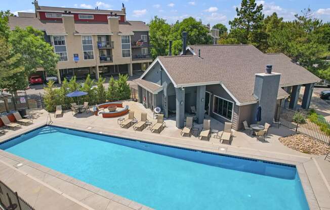 an aerial view of a swimming pool and a house with a pool